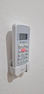 a remote control is attached to a wall at FATINN'S surf Apartements in Airsatang