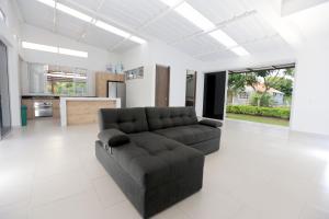 uma sala de estar com um sofá e uma cozinha em Finca Hotel Mana em Guamal