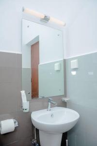 a bathroom with a white sink and a mirror at Apartment -Piliyandala Kahathuduwa in Gonapola