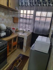 a kitchen with a sink and a refrigerator in it at Weli Glamorous homestay in Naivasha