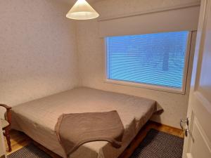 a small bedroom with a bed and a window at Villa Lumia in Paranen