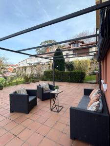 a patio with couches and a table on a patio at LA TERRAZA in Comillas