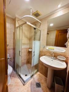 a bathroom with a shower and a sink at Nada Al Majd Hotel in Mecca