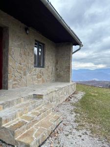 a stone building with a window and some stairs at Chata Nemcová - Muránska planina in Muráň