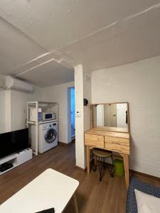 a living room with a wooden table in a room at B My Guesthouse in Seoul