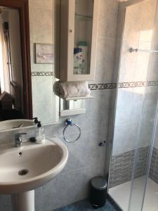 a bathroom with a sink and a shower at LA TERRAZA in Comillas