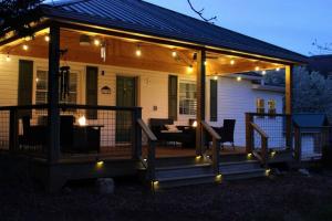 a screened porch with lights on a house at The Bailey Hot Springs in Hot Springs