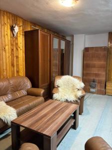 a living room with a couch and a coffee table at Chata Nemcová - Muránska planina in Muráň