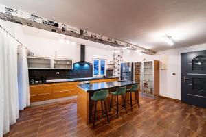 a kitchen with a counter and some bar stools at Šanić Apartments 543/a in Lopar