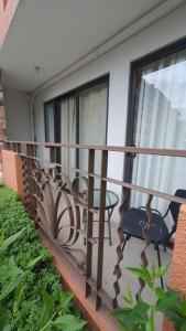 a balcony with two chairs and a table on it at MetroStay Oasis in Cebu City