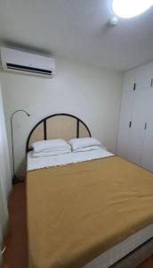 a small bedroom with a bed with angth at MetroStay Oasis in Cebu City
