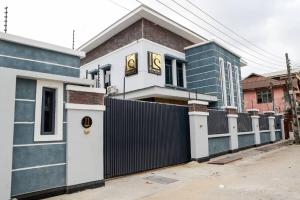 a house with a fence in front of it at THE KINGSLEY La -PRIMA CASA HOTEL in Lagos