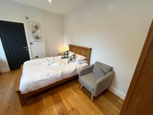 a small bedroom with a bed and a chair at NEW King Bed Romantic Cabin - Must See Landscapes in Salisbury