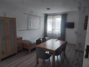 a room with a table and chairs and a bed at Apartament Tczew-duże pokoje! in Tczew