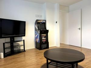 a living room with a table and a video game at Essex 2 Bedroom Flat near Station with Free Parking in North Ockendon