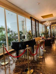 a large lobby with a red rope around a tub at Ivy Thonglor in Khlong Toei