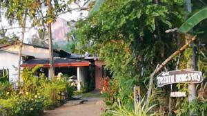 a street sign in front of a house at Tezara Home Stay in Sigiriya