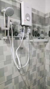 a hair dryer on the wall of a bathroom at Tezara Home Stay in Sigiriya