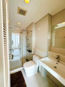 a bathroom with a toilet and a sink and a shower at Ivy Thonglor in Khlong Toei