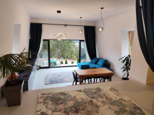 a living room with a blue couch and a table at Vila Plava Zlatar in Brdo