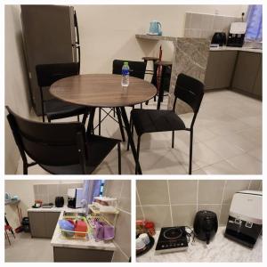 a kitchen and a table and chairs in a kitchen at Hayyan Homestays in Kuantan