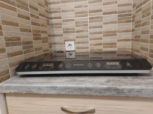 a kitchen counter with a stove top in a kitchen at Potyka Apartman in Tiszafüred