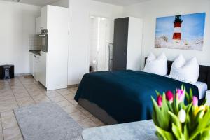 a bedroom with a bed and a red lighthouse at Villa Aida in Ahlbeck