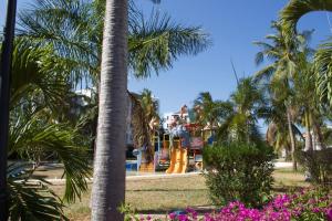 a ride in a park with palm trees and flowers at TAUSI HOMES Sultan Palace Beach Resort in Kilifi