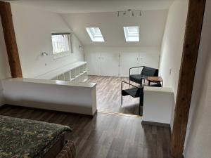 an attic room with a bed and a table and chairs at Ruhige 2 Zimmer Wohnung in Diegten