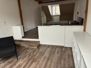 a room with white cabinets and a room with a mirror at Ruhige 2 Zimmer Wohnung in Diegten