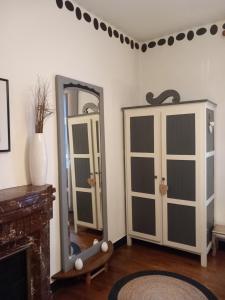 a living room with a mirror and a dresser at Chambre d'hôte & coin petit-déjeuner in Camaret-sur-Mer