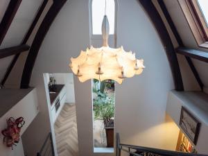 a chandelier hanging from a staircase in a house at Keizersgracht Centre in Amsterdam