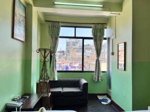 a living room with a couch and a window at Metro Eco Hotel in Kathmandu