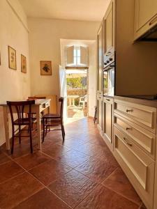 a kitchen with a table and a dining room at La Casa di Orazio in Montecatini Val di Cecina