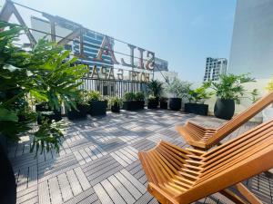 a balcony with benches and potted plants on a building at SILANA HOTEL & APARTMENT in Da Nang