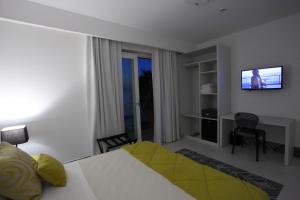 a hotel room with a bed and a television at Palma d'Oro in Bagnara Calabra
