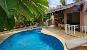a swimming pool in front of a house at WAYNES' VILLA in Flic-en-Flac