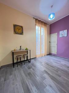 an empty room with a table and a purple wall at Borgo Levano in Licata