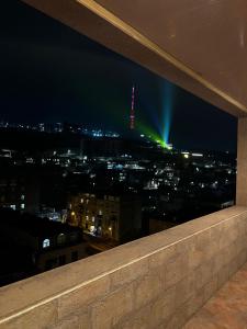 a view of a city at night from a building at Home in Yerevan