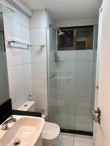 a bathroom with a shower and a toilet and a sink at Manhattan Beach Aquiraz Riviera in Aquiraz