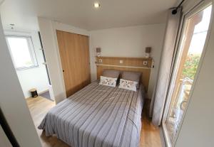 a bedroom with a bed with two pillows on it at Les rives de condrieu in Condrieu