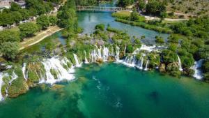 an aerial view of a waterfall in a river at Apartman Ličanka in Muškovci