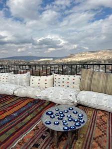 a white couch sitting on top of a balcony at Bedrock Cave Hotel in Göreme