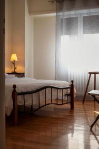 a bedroom with a bed and a window with a curtain at Charming 1Bd apartment in Athens in Athens