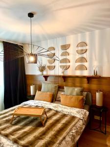 a bedroom with a large bed with a table on it at Window on Crans Montana, Appartement avec vue sur les Alpes in Crans-Montana