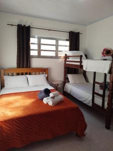 a bedroom with two bunk beds with a stuffed animal on the bed at Casa Zago 1 in Santa Maria Madalena