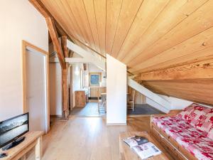 a living room with a large wooden ceiling at Appartement Chamonix-Mont-Blanc, 3 pièces, 6 personnes - FR-1-343-200 in Chamonix