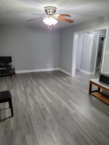 an empty living room with a ceiling fan at Individual home in Brampton