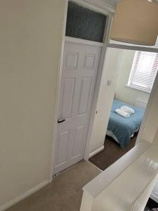 a bedroom with a door and a bed in it at Rotherham,Meadowhall,Magna,Utilita Arena,with WIFi and Driveway in Kimberworth