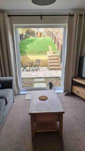 a living room with a couch and a coffee table at Rotherham Kimberworth home from home with WIFi and Driveway in Kimberworth